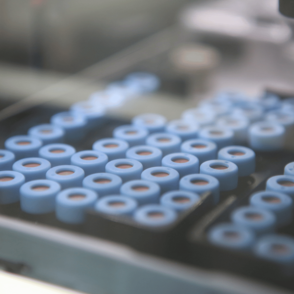 Black plastic tray holding blue capped HPLC vial samples for analytical HPLC assay testing at Nanopharm.